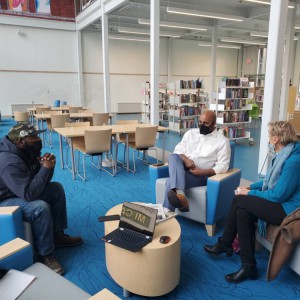 Hartford Land Bank Chief Executive Officer Arunan Arulampalam, center, holds office hours at the Park Street Library @ the Lyric last month.