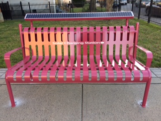 A solar-powered charging bench outside the Camp Field Library.
