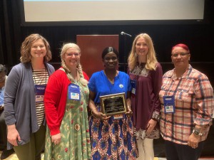 Lina Osho-Williams, center, accepts the Faith Hektoen Award at the Connecticut Library Associations annual conference in Hartford last week. Standing with her, from left to right, are HPL Director of Public Services Marie Jarry, former HPL Assistant Director of Youth and Family Services Denise Martens, HPL Branch Services Coordinator Bonnie Solberg and HPL children's librarian Linda Montanez.