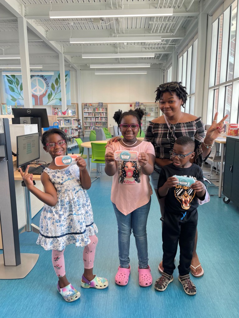 Children show off the new eyeglasses they received at the Park Street Library @ the Lyric last month as part of a partnership between Hartford Public Library and the nonprofit Vision to Learn.